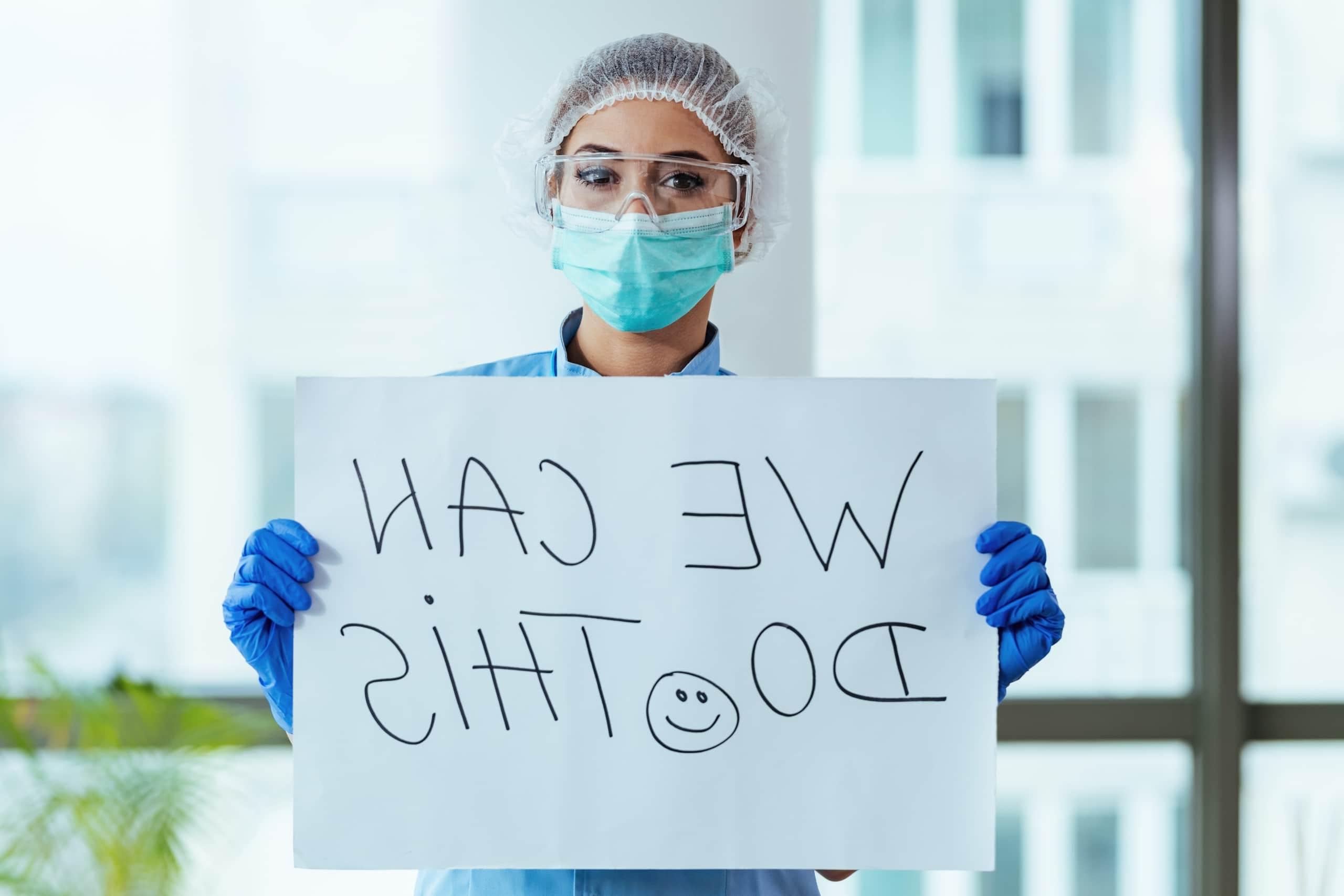 Nurse holding a motivational sign